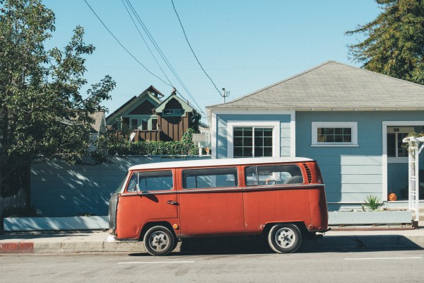 red van in front of house with roofing shingles