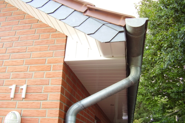 a half round gutter system with a steel downspout