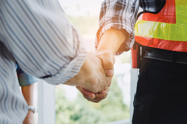 homeowner and roofing contractor shaking hands 