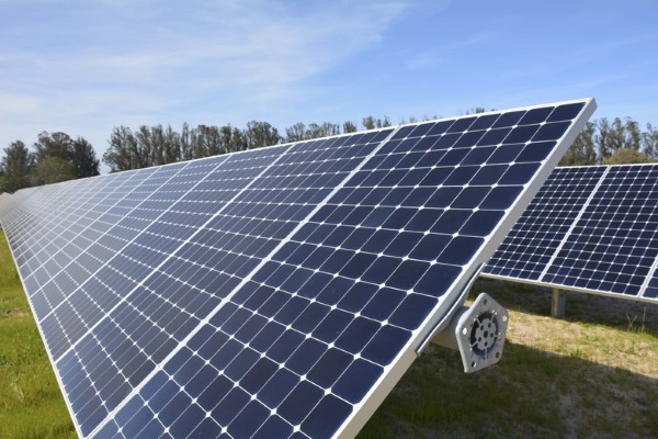 ground-mounted solar panels on a wide lawn